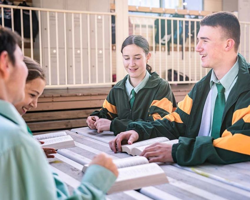 Senior school students taking part in a Bible study lesson outside, deepening their spiritual understanding